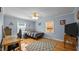 Cozy bedroom with light blue walls, ceiling fan, and natural light from two windows at 1926 Downing Dr, Burlington, NC 27215