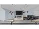 Spacious bonus room with a large sectional sofa and entertainment center at 1926 Downing Dr, Burlington, NC 27215