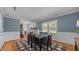 Dining room with hardwood floors, modern decor, and a view of the entryway and a bedroom at 1926 Downing Dr, Burlington, NC 27215