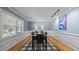 Formal dining room with decorative wainscoting, light blue walls, and a large window at 1926 Downing Dr, Burlington, NC 27215
