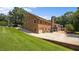 Rear exterior view of brick home featuring a well-maintained lawn, garage, and patio at 1926 Downing Dr, Burlington, NC 27215