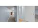 Upstairs hallway with neutral walls, carpet, and access to rooms at 1926 Downing Dr, Burlington, NC 27215