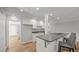 Well-lit kitchen featuring an island with a cooktop, bar seating, and ample cabinet space for storage at 1926 Downing Dr, Burlington, NC 27215