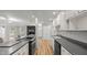 Open-concept kitchen with an island, sleek countertops, and a view of the living area with a fireplace at 1926 Downing Dr, Burlington, NC 27215