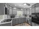 Modern kitchen featuring stainless steel appliances, white countertops, and ample cabinet space at 1926 Downing Dr, Burlington, NC 27215