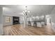 Inviting living room with a fireplace, hardwood floors, and a view of the open kitchen and dining area at 1926 Downing Dr, Burlington, NC 27215