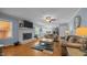 Bright living room with hardwood floors, a brick fireplace, and access to the kitchen at 1926 Downing Dr, Burlington, NC 27215