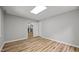 An empty bonus room with neutral paint and vinyl flooring offers flexible opportunities for customization at 1926 Downing Dr, Burlington, NC 27215
