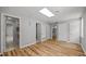 A room with wood floors, gray walls, and multiple doors and closets offers flexible living space at 1926 Downing Dr, Burlington, NC 27215