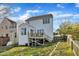View of backyard with wood deck and two-story home featuring white siding and a well-maintained lawn at 1968 Shadow Glen Dr, Raleigh, NC 27604