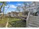 Backyard featuring a wooden deck and steps, fenced-in yard, and green grass at 1968 Shadow Glen Dr, Raleigh, NC 27604