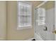 This full bathroom features a shower and tub combo with clear glass door and window at 1968 Shadow Glen Dr, Raleigh, NC 27604
