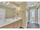 Bright bathroom features double sinks and a large mirror over a vanity with plenty of storage at 1968 Shadow Glen Dr, Raleigh, NC 27604