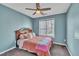 Cozy bedroom with a ceiling fan, window with blinds and a comfortable bed at 1968 Shadow Glen Dr, Raleigh, NC 27604