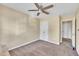 This carpeted bedroom features a ceiling fan, closet, and entrance to the rest of the home at 1968 Shadow Glen Dr, Raleigh, NC 27604