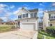 Traditional home with a driveway leading to an attached garage, set against a backdrop of a bright blue sky at 1968 Shadow Glen Dr, Raleigh, NC 27604