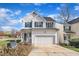 Traditional two-story home featuring an attached garage, white siding, green shutters, and a well-kept front yard at 1968 Shadow Glen Dr, Raleigh, NC 27604