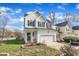 Exterior view of a well-maintained home with a green front door, complemented by mature landscaping and a paved driveway at 1968 Shadow Glen Dr, Raleigh, NC 27604
