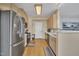 Spacious kitchen with stainless steel refrigerator, light wood cabinets, and a hardwood floor at 1968 Shadow Glen Dr, Raleigh, NC 27604