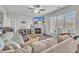 Living room showcasing a large sectional, fireplace with mounted TV, and natural light streaming through the windows at 1968 Shadow Glen Dr, Raleigh, NC 27604