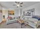 Spacious living room showcases a plush sectional, ceiling fan, and an open layout leading into the kitchen area at 1968 Shadow Glen Dr, Raleigh, NC 27604