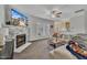 Cozy living room with a stone fireplace, large sectional, ceiling fan, and open access to the kitchen at 1968 Shadow Glen Dr, Raleigh, NC 27604