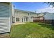 Large, well-maintained backyard featuring a lush lawn, a wooden pergola, and a charming privacy fence at 2000 Silky Dogwood Trail Trl, Apex, NC 27502