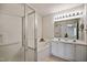 Bright bathroom featuring double vanity, separate shower with glass enclosure, and soaking tub at 2000 Silky Dogwood Trail Trl, Apex, NC 27502