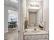 Well-lit half bathroom featuring a marble vanity and decorative accents at 2000 Silky Dogwood Trail Trl, Apex, NC 27502