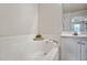 Close-up view of the bathtub and vanity in the well-lit bathroom at 2000 Silky Dogwood Trail Trl, Apex, NC 27502