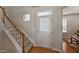 Inviting entryway with a staircase and decorative front door, leading to a bright, open interior at 2000 Silky Dogwood Trail Trl, Apex, NC 27502