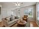 Inviting living room with neutral decor, a ceiling fan, and views of the landscaped yard at 2000 Silky Dogwood Trail Trl, Apex, NC 27502