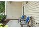 Cozy porch featuring wicker seating with blue pillows, perfect for relaxing outdoors at 2000 Silky Dogwood Trail Trl, Apex, NC 27502