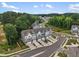 Aerial view of modern townhomes, winding streets, and lush greenery in a planned community at 2006 Leo Dr, Apex, NC 27502