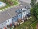 Aerial view showcasing townhomes with decks and patios, surrounded by manicured lawns and trees at 2006 Leo Dr, Apex, NC 27502