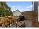 Relax on the expansive wooden deck, perfect for outdoor dining and entertaining with stylish seating and a grill at 2006 Leo Dr, Apex, NC 27502