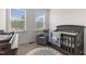 This cozy Bedroom features a comfortable rocker, crib, and cheerful decor for a serene environment at 2006 Leo Dr, Apex, NC 27502