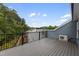 A spacious wooden deck with black railings overlooks lush green trees, providing an outdoor retreat at 2006 Leo Dr, Apex, NC 27502
