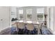 Bright dining area features white table, six chairs, and views of the community pool at 2006 Leo Dr, Apex, NC 27502