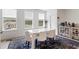 Sunlit dining area with white table, six chairs, and a view of the community pool at 2006 Leo Dr, Apex, NC 27502