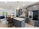 Modern kitchen boasts stainless steel appliances, gray cabinetry, a spacious island, and stylish pendant lighting at 2006 Leo Dr, Apex, NC 27502