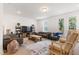 Spacious living room with modern furnishings, neutral tones, and ample natural light provides a comfortable gathering space at 2006 Leo Dr, Apex, NC 27502