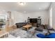 Open-concept living room boasts modern furnishings, neutral décor, and ample natural light for a welcoming ambiance at 2006 Leo Dr, Apex, NC 27502