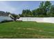 Expansive backyard featuring a lush green lawn and a pristine white privacy fence at 2013 Woodbluff Dr, Wendell, NC 27591