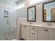 Bright bathroom featuring double sinks, sleek countertops, and a glass-enclosed walk-in shower with tile at 2013 Woodbluff Dr, Wendell, NC 27591