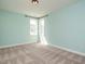 This light-filled bedroom features soft carpet, neutral walls, and natural light from two windows at 2013 Woodbluff Dr, Wendell, NC 27591