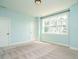 Light-filled bedroom features a large window offering outdoor views, carpeted floors, and neutral paint at 2013 Woodbluff Dr, Wendell, NC 27591