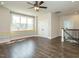Upstairs bonus room with wood floors, large window, and access to staircase at 2013 Woodbluff Dr, Wendell, NC 27591