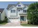 Charming home featuring light blue siding, white trim, an attached garage, and a welcoming front porch at 2013 Woodbluff Dr, Wendell, NC 27591