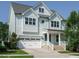 Beautiful home features light blue siding, white trim, well-manicured lawn, attached garage, and inviting entrance at 2013 Woodbluff Dr, Wendell, NC 27591